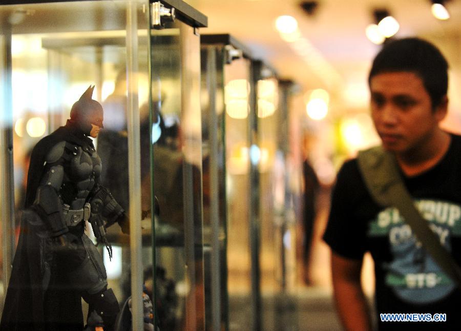 A man looks at a toy animation character of Batman displayed at a shopping center as part of Batman 75th anniversary exhibition in Jakarta, Indonesia, June 27, 2014. 