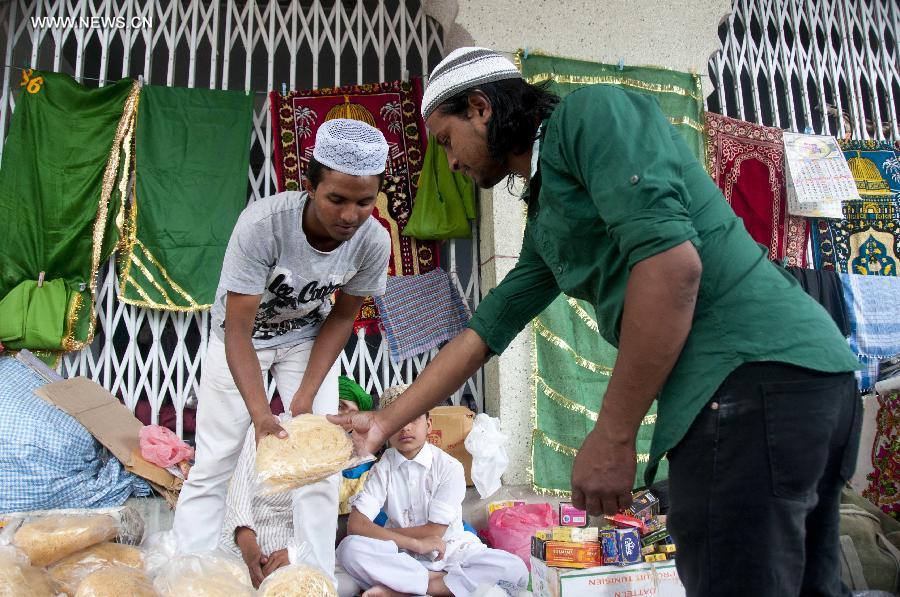 Muslims buy food at a local mosque for breaking their fast during Islamic holy month of Ramadan in Kathmandu, Nepal, July 4, 2014. Muslims around the world refrain from eating, drinking and smoking from dawn to dusk during the fasting month of Ramadan.