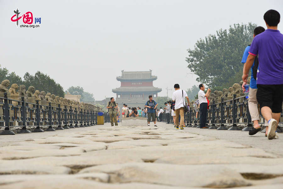 People visit the Marco Polo Bridge (aka. Lugouqiao in Chinese) on July 7, 2014, the 77th anniversary of the Marco Polo Bridge Incident (1937), which marks the full breakout of the Chinese people's war of resistance against Japanese invasion. [Photo by Chen Boyuan / China.org.cn]