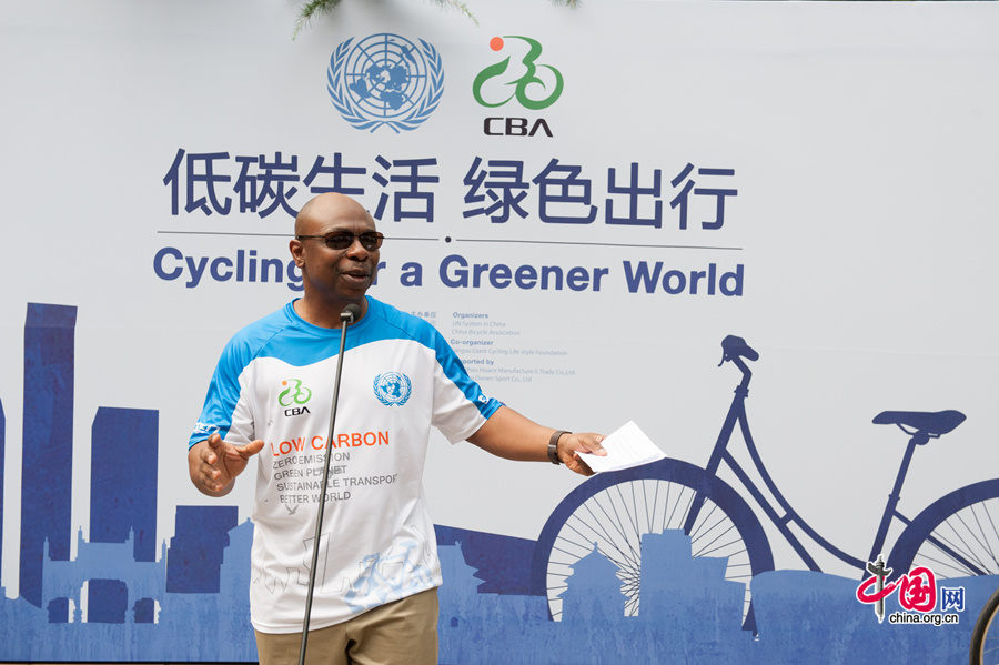 Alain Noudehou, the new UN Resident Coordinator in China, delivers a keynote speech at &apos;Cycling for a Greener World&apos; green traffic promotion on Friday afternoon, July 18, 2014, at the United Nations China headquarters in Beijing. [Photo by Chen Boyuan / China.org.cn]