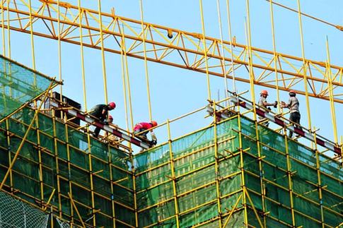 Workers at a construction project in Qingdao, Shandong province.China will revive mortgage-backed debt sales this week after a six-year hiatus, as the government extends more help to homebuyers in a flagging property market. [China Daily]