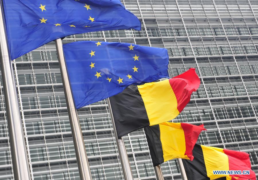European Union and Belgian flags are seen outside the headquarters of EU Commission, at the National Day of Belgium in Brussels, Belgium, on July 21, 2014. [Photo/Xinhua]