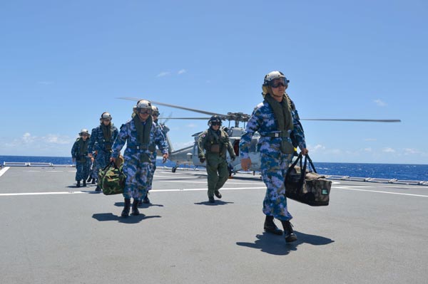 The Chinese military medical officers, who concluded their visit to the US hospital ship Mercy, land on the PLA hospital ship Peace Ark by helicopter, along with medical officers from the Mercy ship to visit the Peace Ark ship, July 18, 2014. [Photo/Xinhua] 