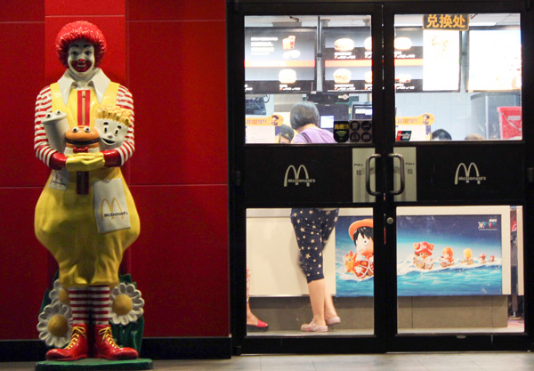A customer shops at a McDonald's in Mudanyuan, Beijing, on Sunday. The shop has shelved all meat products. Wang Zhuangfei / China Daily