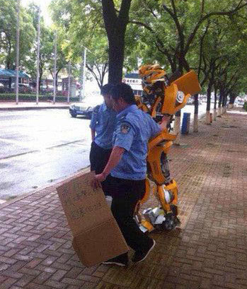 A Chinese man dressed as a Transformer begging money to return to home planet was taken away by the local urban management officers in Chengdu, Sichuan Province. 