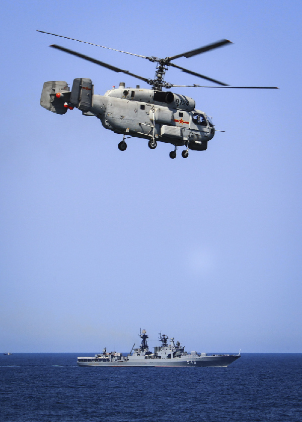 An anti-submarine helicopter searches for submerged craft during exercise. 