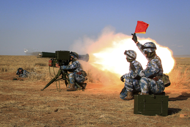 Marines fire anti-tank missiles during a drill at a training base. 