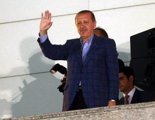 Newly elected Turkish president Recep Tayyip Erdogan waves at supporters from the balcony of the AKP party headquarters during the celebrations of his victory in the presidential election vote in Ankara on August 10, 2014. [Xinhua photo]