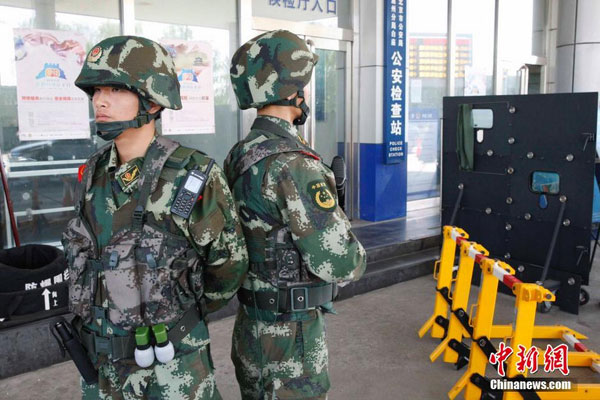 Beijing police authorities perform security checks on various vehicles entering the capital city on August 12, 2014.
