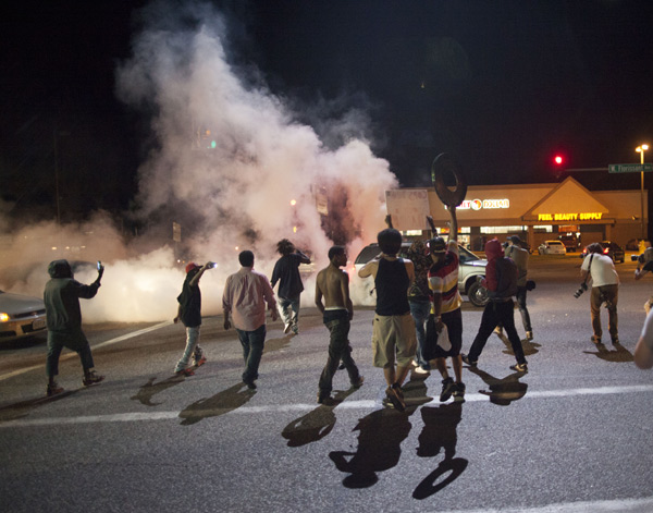 Protesters shout slogans during a demonstration in Ferguson, Missouri, the United States, on Aug. 15, 2014. 18-year-old African American teen Michael Brown was shot and killed in Ferguson by local police on Aug. 9, 2014. 