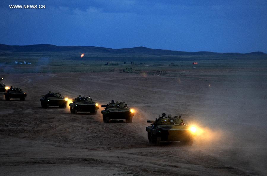 Armored vehicles of foreign troops are seen at the Zhurihe training base, north China's Inner Mongolia Autonomous Region, Aug. 16, 2014. A total of some 2,200 troops on Monday arrived at the Zhurihe training base, where 'Peace Mission-2014,' a drill under the Shanghai Cooperation Organization (SCO) framework, will run from Aug. 24-29.
