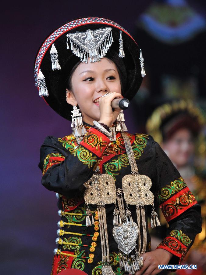 A woman of the Yi ethnic group performs during a talent show of a traditional beauty contest at Xichang City, southwest China's Sichuan Province, July 23, 2014. The beauty contest is one of the most important activities during the annual Torch Festival at Liangshan Yi Autonomous Prefecture. It can date back to over 1,000 years ago in the history of the Yi ethnic group. (Xinhua/Xue Yubin)