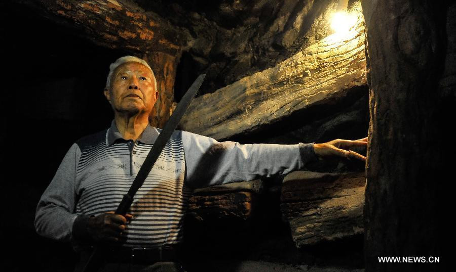 Liu Qixiang, a surviving forced miner who worked for Japan during the World War II, recalls the past at a museum of Liaoyuan miners' tomb during Japanese occupation in Liaoyuan, Northeast China's Jilin province, Aug 28, 2014