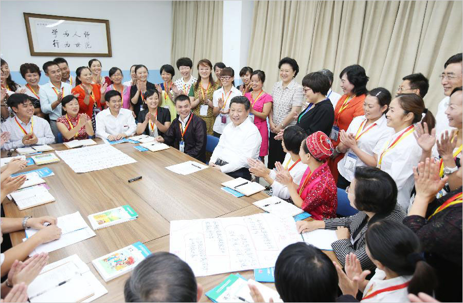 Chinese President Xi Jinping talks with primary school teachers attending a training program at Beijing Normal University in Beijing, capital of China, Sept. 9, 2014. Xi made an inspection tour to Beijing Normal University Tuesday, the eve of Teachers' Day in China. [Photo: Xinhua/Yao Dawei] 