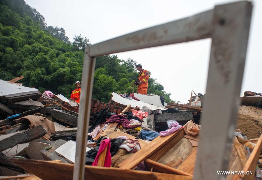 Rescuers use a life detector to search for survivers at a landslide site in Changsheng Village of Changshou District in southwest China's Chongqing, Sept. 14, 2014. Downpours are wreaking havoc in southwest China Saturday. Landslides triggered by continuous rainfalls have killed at least three people here and more buried are yet to be found. (Xinhua/Liu Chan)