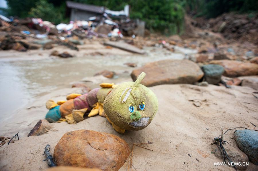 Photo taken on Sept. 14, 2014 shows a toy found at a landslide site in Changsheng Village of Changshou District in southwest China's Chongqing. Downpours are wreaking havoc in southwest China Saturday. Landslides triggered by continuous rainfalls have killed at least three people here and more buried are yet to be found. (Xinhua/Liu Chan)