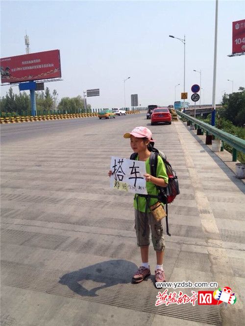Liu holds a sign: 'Free Ride' at the entrance of a high-speed way. [Photo: yzdsb.com.cn] 