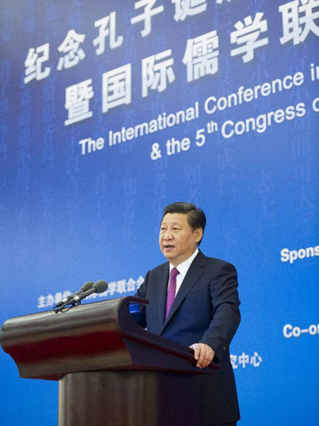 Chinese President Xi Jinping addresses an international seminar to mark the 2,565th anniversary of the birth of Confucius, which is concurrent with the Fifth Congress of the International Confucian Association (ICA), at the Great Hall of the People in Beijing, capital of China, Sept. 24, 2014. [Photo: Xinhua/Huang Jingwen] 