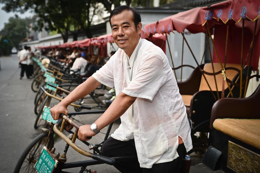 Rickshaw driver Cao Junlai at Shichahai area in Beijing, Sept 12, 2014. [Photo/Xinhua]