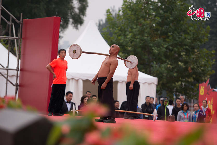 Chaoyang Park in the eastern downtown of Beijing, capital of China, stages grand commemorative activities on Wednesday, Oct. 1, 2014, to mark the 65th National Day holiday of the People&apos;s Republic of China, which was founded on Oct. 1, 1949. The celebrations at Chaoyang Park are in sync with similar activities in all of the around 300 parks in Beijing on this day. [Photo by Chen Boyuan / China.org.cn]