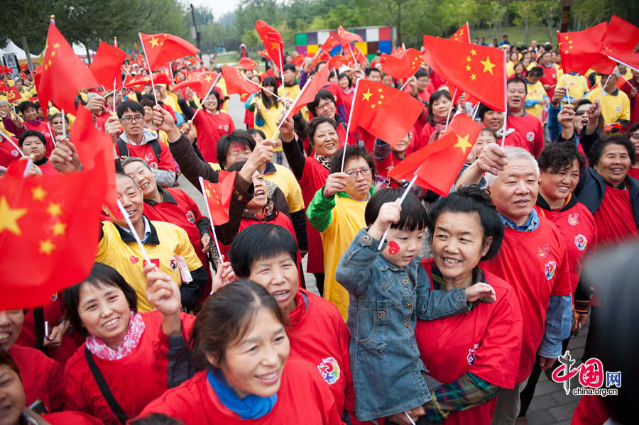 Chaoyang Park in the eastern downtown of Beijing, capital of China, stages grand commemorative activities on Wednesday, Oct. 1, 2014, to mark the 65th National Day holiday of the People&apos;s Republic of China, which was founded on Oct. 1, 1949. The celebrations at Chaoyang Park are in sync with similar activities in all of the around 300 parks in Beijing on this day. [Photo by Chen Boyuan / China.org.cn]