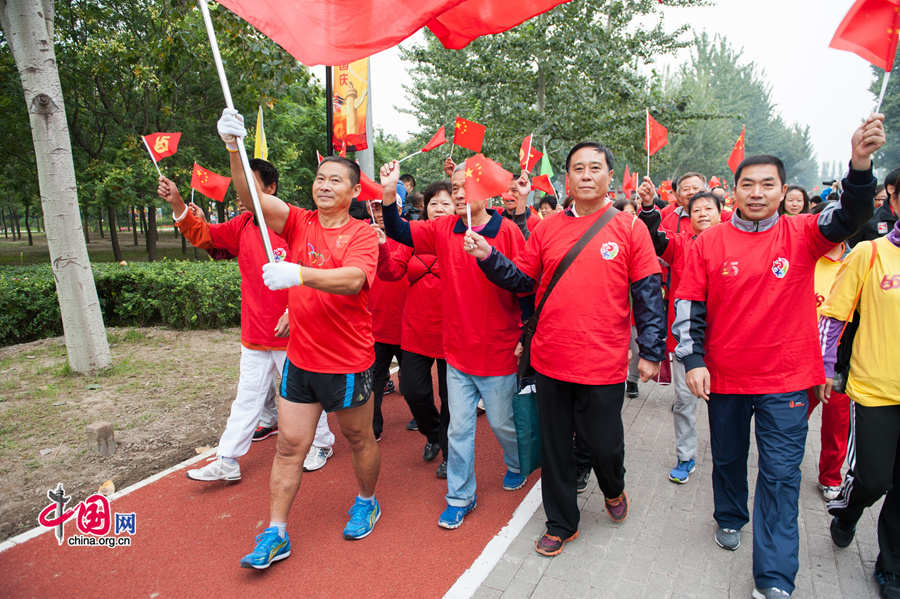 Chaoyang Park in the eastern downtown of Beijing, capital of China, stages grand commemorative activities on Wednesday, Oct. 1, 2014, to mark the 65th National Day holiday of the People&apos;s Republic of China, which was founded on Oct. 1, 1949. The celebrations at Chaoyang Park are in sync with similar activities in all of the around 300 parks in Beijing on this day. [Photo by Chen Boyuan / China.org.cn]