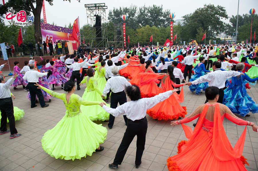 Chaoyang Park in the eastern downtown of Beijing, capital of China, stages grand commemorative activities on Wednesday, Oct. 1, 2014, to mark the 65th National Day holiday of the People&apos;s Republic of China, which was founded on Oct. 1, 1949. The celebrations at Chaoyang Park are in sync with similar activities in all of the around 300 parks in Beijing on this day. [Photo by Chen Boyuan / China.org.cn]