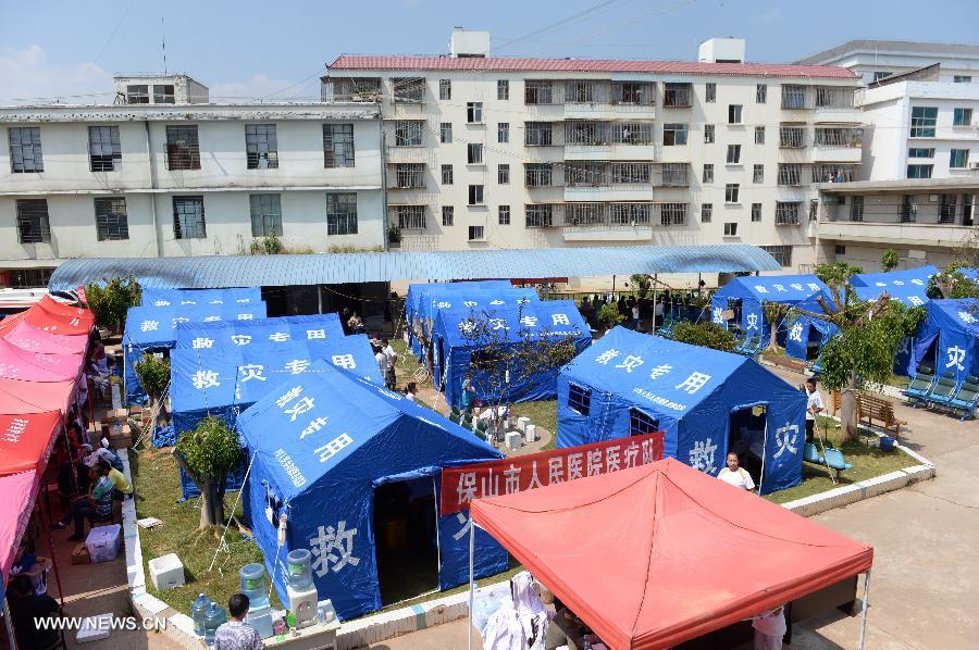 Photo taken on Oct. 8, 2014 shows a temporary medical center organized by the 2nd Renmin Hospital of Jinggu County, southwest China&apos;s Yunnan Province. One person died and 324 others were injured after a 6.6-magnitude quake jolted Yunnan Province Tuesday night, according to local government. Injured villagers have been sent for medical treatment. 