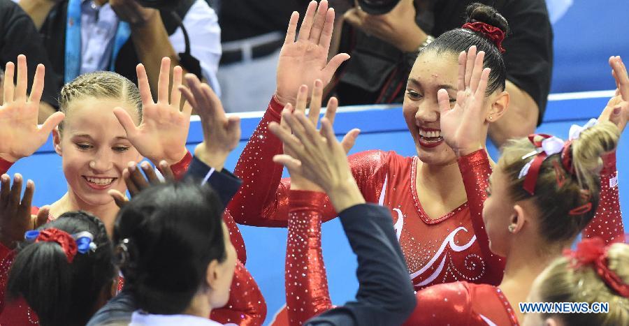 Gymnasts of team USA celebrates after winning the women&apos;s team final of the 45th Gymnastics World Championships in Nanning, capital of south China&apos;s Guangxi Zhuang Autonomous Region, Oct. 8, 2014. USA team won the title with a total of 179.280 points.