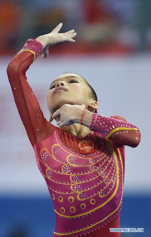 Chinese gymnast Shang Chunsong performs in the floor exercise during the women&apos;s team final of the 45th Gymnastics World Championships in Nanning, capital of south China&apos;s Guangxi Zhuang Autonomous Region, Oct. 8, 2014. Chinese team won the silver medal with a total of 172.587 points.