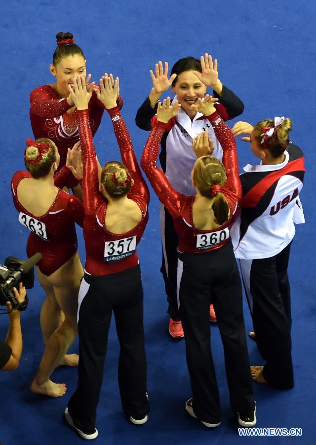 Gymnasts and coaches of team USA celebrate after winning the women&apos;s team final of the 45th Gymnastics World Championships in Nanning, capital of south China&apos;s Guangxi Zhuang Autonomous Region, Oct. 8, 2014. Team USA won the title with a total of 179.280 points. 
