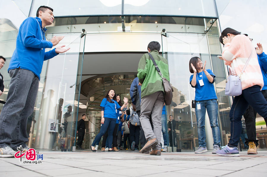 Staff members at Apple&apos;s Wangfujing Store welcome its first batch of customers of iPhone 6 and iPhone 6 Plus on the morning of Oct. 17, the date when the two phones are launched in the Chinese mainland. [Photo by Chen Boyuan / China.org.cn]