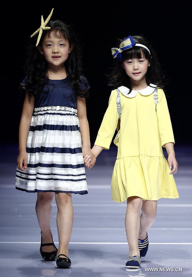 Child models present creations designed by Dong Wenmei during China Fashion Week in Beijing, capital of China, Oct. 29, 2014. [Xinhua]