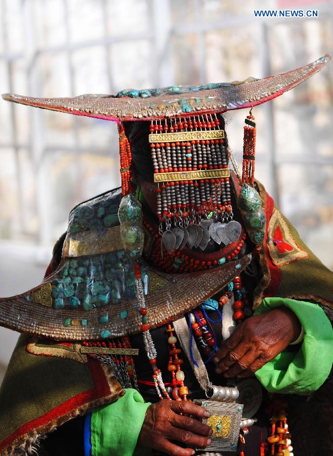 A woman presents Burang costume at Kegya Village in Burang County of Nagri Prefecture, southwest China's Tibet Autonomous Region, Oct. 23, 2014. 