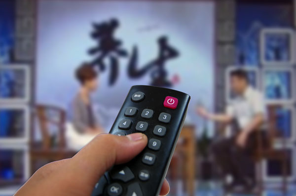 Chinese characters shown on a health TV show read 'keeping fit'. [China Daily] 