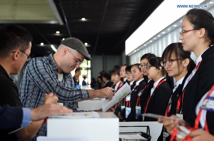 A participant fills in a form at the registration center for the 2014 APEC Economic Leaders' Week in Beijing, China, Nov. 3, 2014. The registration center for the APEC meeting in Beijing was officially opened on Monday, providing reception service running from 8:00 a.m. to 6:00 p.m. [Photo/Xinhua]
