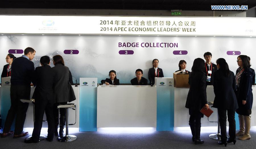 Participants receive their badges at the registration center for the 2014 APEC Economic Leaders' Week in Beijing, China, Nov. 3, 2014. The registration center for the APEC meeting in Beijing was officially opened on Monday, providing reception service running from 8:00 a.m. to 6:00 p.m. [Photo/Xinhua]