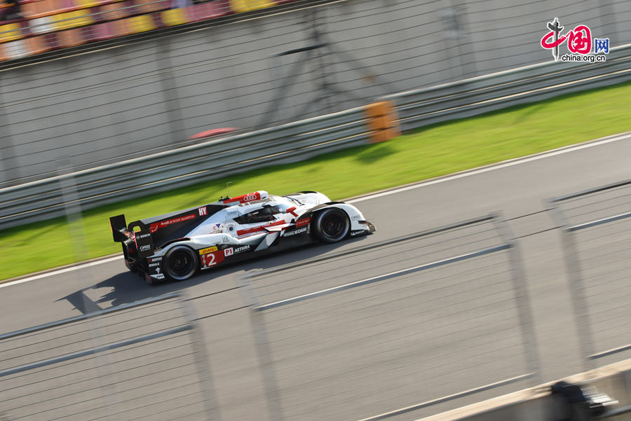 Motor racing teams that include Aston Martin, Ferrari, Porsche, Audi and Toyota compete in the Shanghai grand prix of the FIA World Endurance Championship on Sunday, Nov.2, 2014. Toyota won the GTE professional award and Aston Martin, whose cars are partly powered by Hanergy solar panels, pocketed the first and second prizes of the GTE amateur award. [Photo by Chen Boyuan / China.org.cn] 