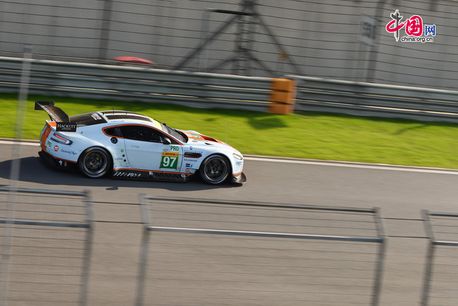 Motor racing teams that include Aston Martin, Ferrari, Porsche, Audi and Toyota compete in the Shanghai grand prix of the FIA World Endurance Championship on Sunday, Nov.2, 2014. Toyota won the GTE professional award and Aston Martin, whose cars are partly powered by Hanergy solar panels, pocketed the first and second prizes of the GTE amateur award. [Photo by Chen Boyuan / China.org.cn] 