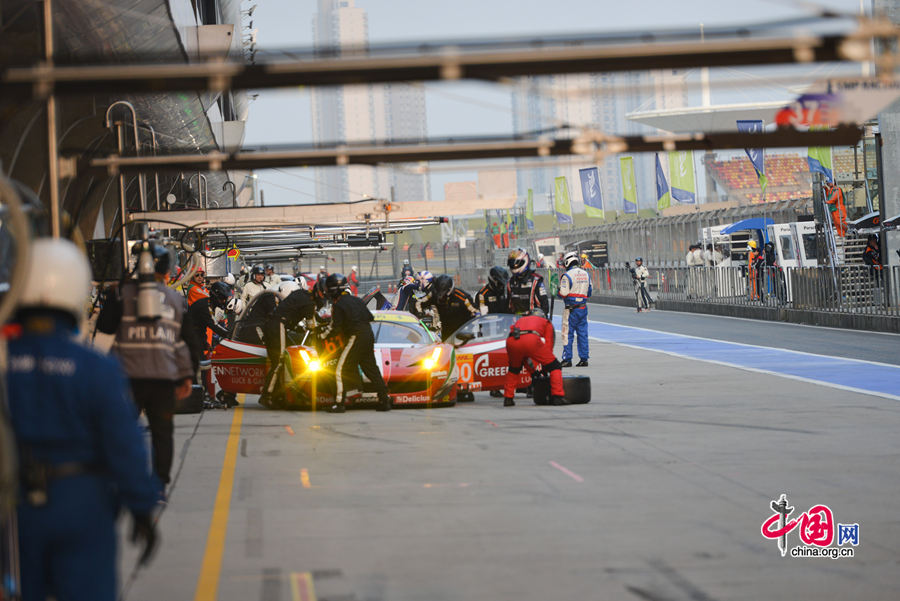 Motor racing teams that include Aston Martin, Ferrari, Porsche, Audi and Toyota compete in the Shanghai grand prix of the FIA World Endurance Championship on Sunday, Nov.2, 2014. Toyota won the GTE professional award and Aston Martin, whose cars are partly powered by Hanergy solar panels, pocketed the first and second prizes of the GTE amateur award. [Photo by Chen Boyuan / China.org.cn] 