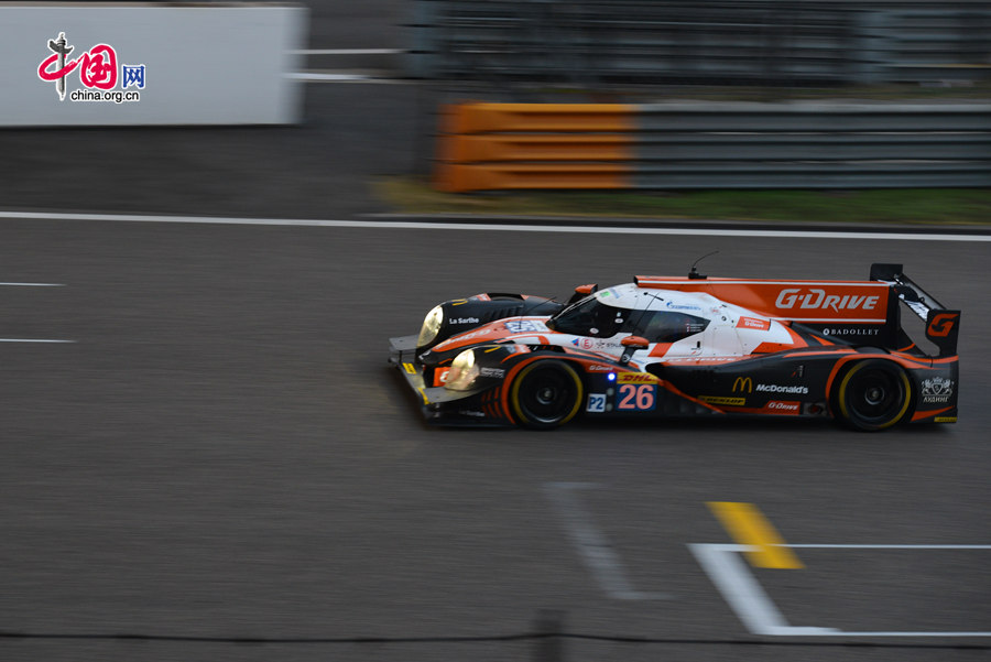 Motor racing teams that include Aston Martin, Ferrari, Porsche, Audi and Toyota compete in the Shanghai grand prix of the FIA World Endurance Championship on Sunday, Nov.2, 2014. Toyota won the GTE professional award and Aston Martin, whose cars are partly powered by Hanergy solar panels, pocketed the first and second prizes of the GTE amateur award. [Photo by Chen Boyuan / China.org.cn]