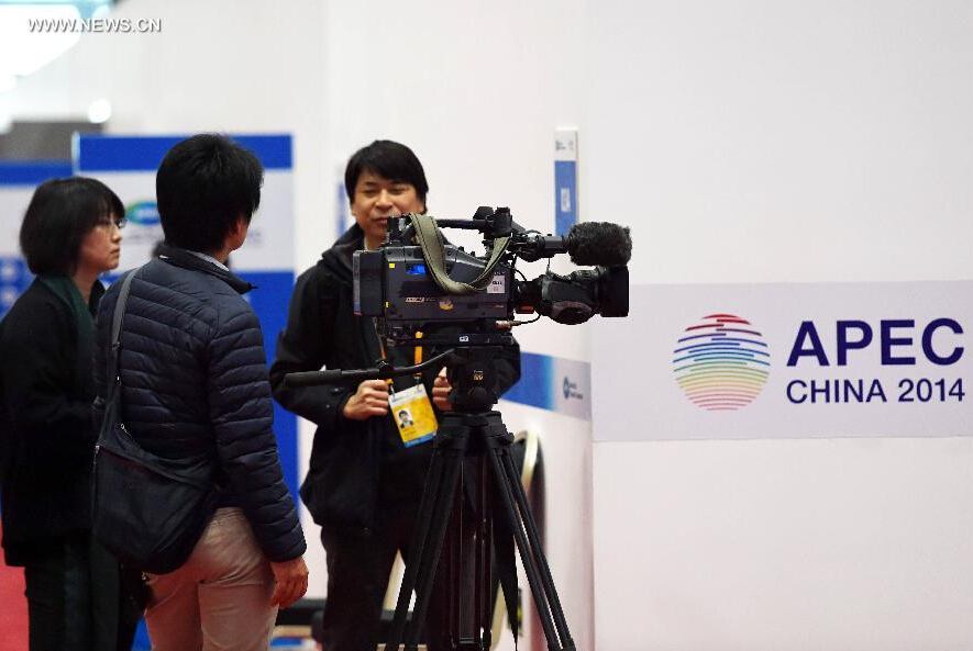 Journalists work in the media center for the 2014 Asia-Pacific Economic Cooperation (APEC) Economic Leaders' Week at China National Convention Center (CNCC) in Beijing, capital of China, Nov. 4, 2014. The 2014 APEC Economic Leaders' Week will be held in Beijing from Nov. 5 to 11. The media center at CNCC opened to media on Tuesday to provide all-round services to media organizations. (Xinhua/Chen Yehua) 