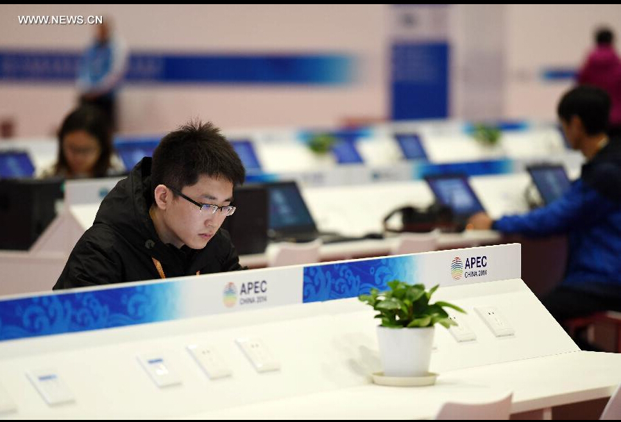 A journalist works in the media center for the 2014 Asia-Pacific Economic Cooperation (APEC) Economic Leaders' Week at China National Convention Center (CNCC) in Beijing, capital of China, Nov. 4, 2014. The 2014 APEC Economic Leaders' Week will be held in Beijing from Nov. 5 to 11. The media center at CNCC opened to media on Tuesday to provide all-round services to media organizations. (Xinhua/Chen Yehua)