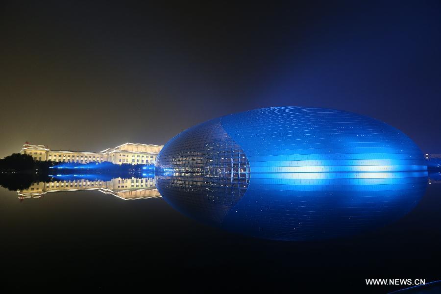 Photo taken on Nov. 4, 2014 shows the illuminated National Center for the Performing Arts in Beijing, capital of China. From Nov. 4 to 11, when 2014 Asia-Pacific Economic Cooperation (APEC) meetings will be held here, the landscape lighting in Beijing will be decorated as in major festivals like the National Day. [Photo/Xinhua] 