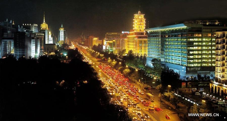 Photo taken on Nov. 4, 2014 shows the illuminated Chang'an Street in Beijing, capital of China. From Nov. 4 to 11, when 2014 Asia-Pacific Economic Cooperation (APEC) meetings will be held here, the landscape lighting in Beijing will be decorated as in major festivals like the National Day. [Photo/Xinhua] 