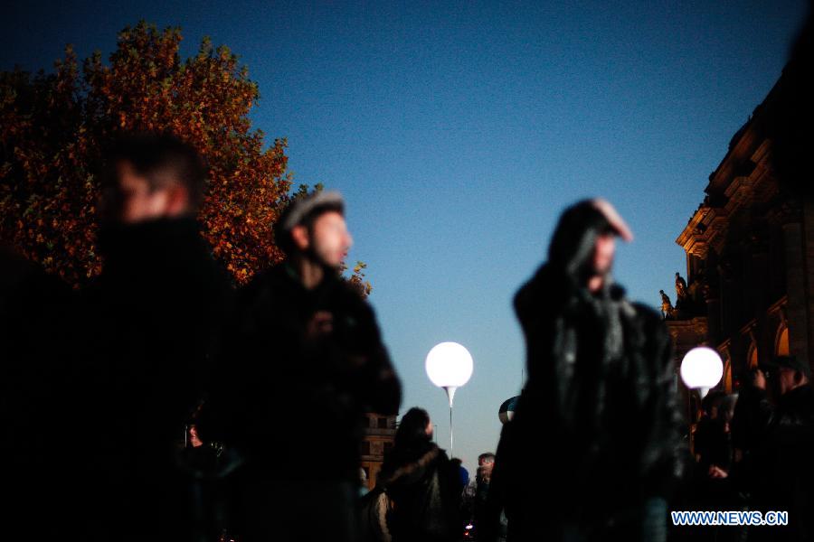 Visitors view a light installation of balloons along the course of former Berlin Wall at a Berlin Wall memorial site in Berlin, Germany, on Nov. 8, 2014.