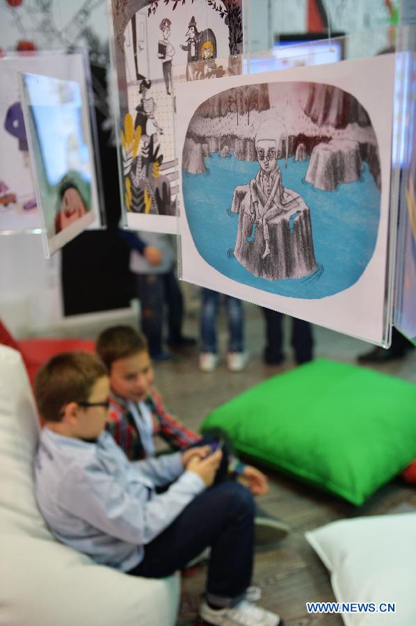 Two boys play in the Hungarian publisher booth in the 33rd International Istanbul Book Fair in Istanbul, Turkey on Nov. 8, 2014. 