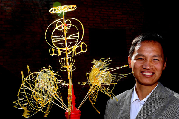 Liu Shengli shows off some of his sugar art creations in Zhengzhou, Henan province, Nov 13, 2014.