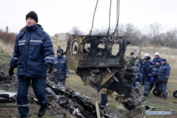 Workers work on the site where the MH17 plane of Malaysia Airlines crashed, on the outskirts of Donetk, eastern Ukraine, on Nov. 16, 2014. Workers began removing the plane's debris four months after its crash which killed 298 people.