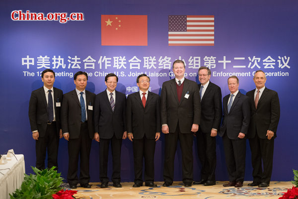 Representatives from China and the United States pose for a photo at the opening ceremony of the 12th Meeting of the China-U.S. Joint Liaison Group on Law Enforcement Cooperation on Wednesday, Dec. 3, 2014 in Beijing, China. [Photo by Chen Boyuan / China.org.cn]